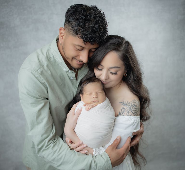 Maternity and newborn portrait by Paulin Photography in Memphis showing mother holding newborn in soft fine-art style