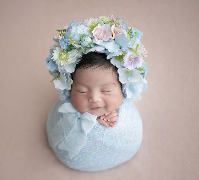 Newborn portrait in Germantown studio with soft natural light and fine-art styling