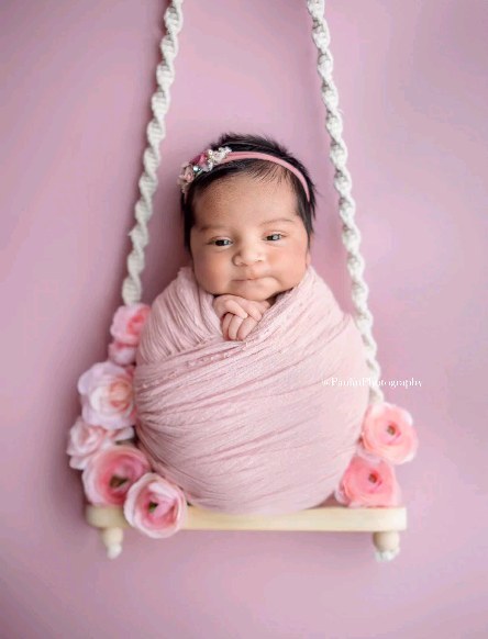 Framed newborn portrait print displayed on a living room wall in Memphis